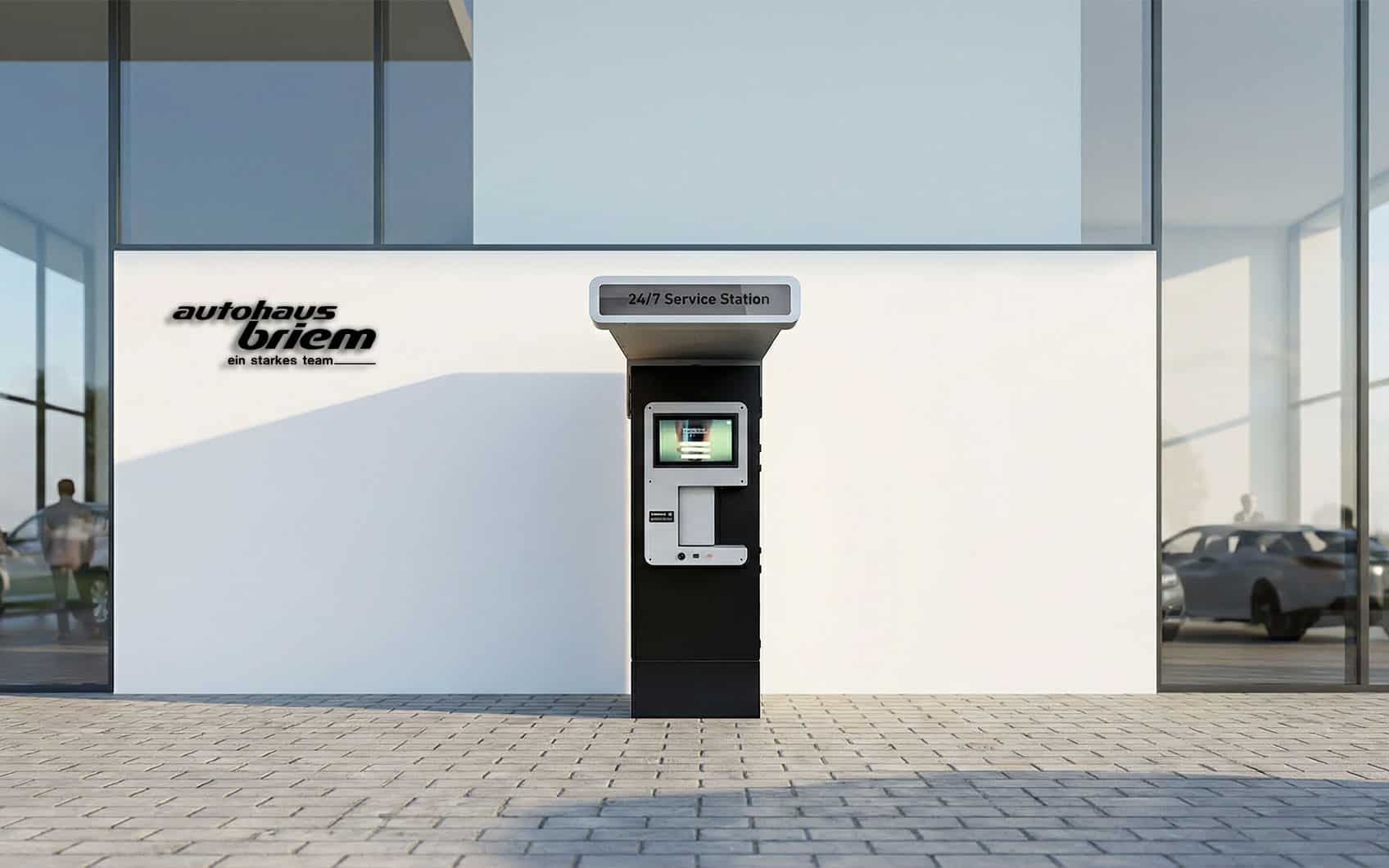 Autohaus Briem-Logo neben 24/7 Service-Station vor moderner Glasfassade